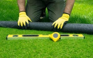 man installing artificial grass