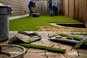 worker installing artificial grass